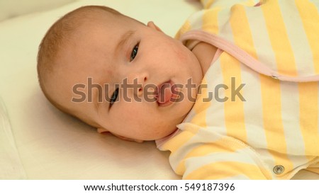 Little newborn baby lying in his bed close-up portrait
