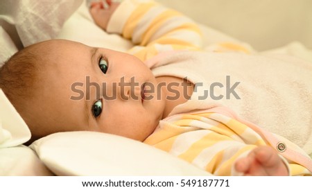 Little newborn baby lying in his bed close-up portrait