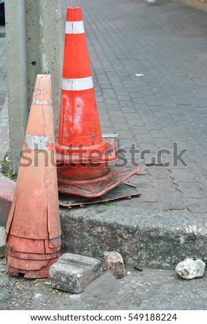 Damage old traffic cones in street of asian country.