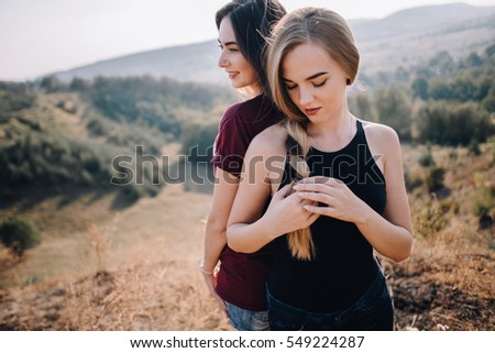Beautiful young girls walk on autumn mountain. female friendship