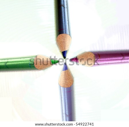 Four crayons in different colours, green, red, black and violet