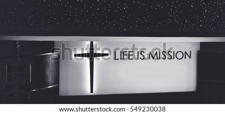Life is mission word sign with cross in church.Black and white tone.
