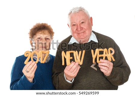 Picture of an elderly couple celebrating new year - isolated background