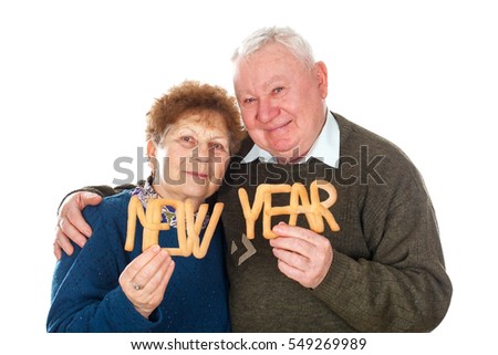 Picture of an elderly couple celebrating new year - isolated background