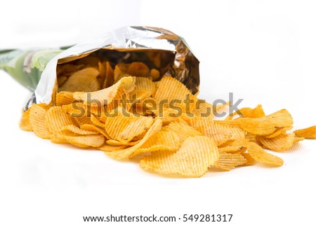 Potato crisp packet opened with crisps spilling out Royalty-Free Stock Photo #549281317