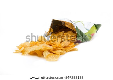 Potato crisp packet opened with crisps spilling out Royalty-Free Stock Photo #549283138