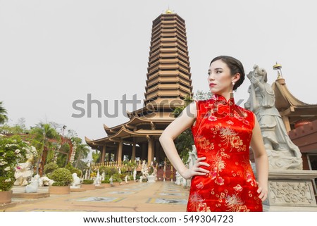 Asian woman posing with chinese temple for chinese new year