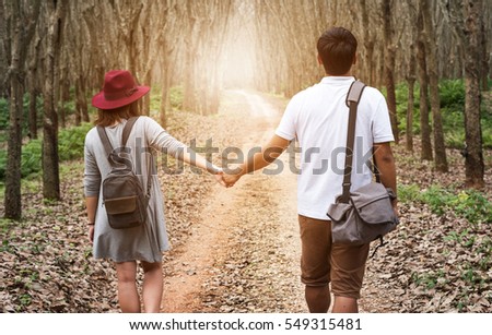 couple in hold hands in the forest.Valentine day.Happy,time,future,expression of my love with his wife.take photo on tripod 
