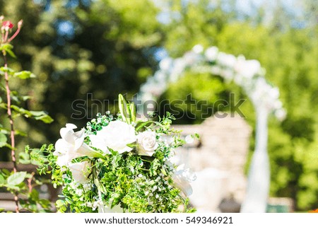 Wedding archway with flowers arranged in park  for a wedding ceremony