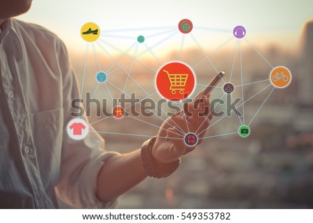 onlien shopping concept.Business man using a touch screen smart phone hands in sunset sky on blurred urban city as background,color filter