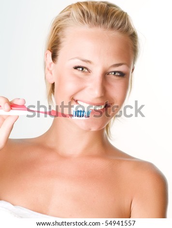 Happy Young Woman Brushing her Teeth