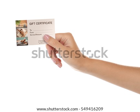 Holiday celebration concept. Female hand with spa service gift certificate on white background