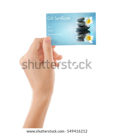 Holiday celebration concept. Female hand with spa service gift certificate on white background