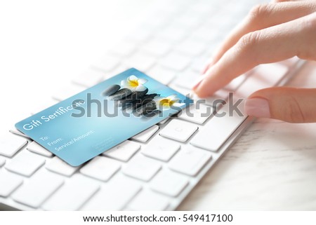 Holiday celebration concept. Spa service gift certificate on keyboard