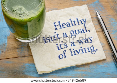 Healthy is not a goal, it is a way of living advice or reminder - handwriting on a napkin with a glass of fresh, green, vegetable juice Royalty-Free Stock Photo #549426589