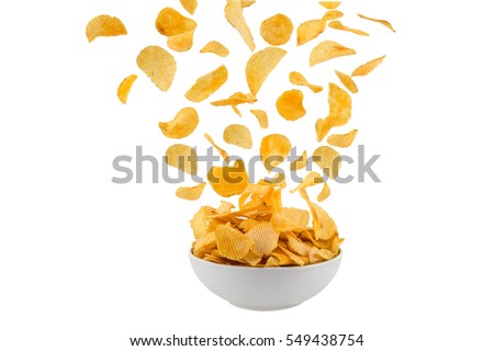 Potato Chips, Crisps coming to bowl on a white background Royalty-Free Stock Photo #549438754