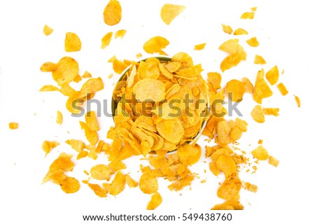 Top view of crisps Crisps in a bowl, crisps scattered around the bowl Royalty-Free Stock Photo #549438760
