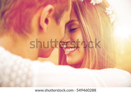 summer holidays, love, romance and people concept - happy smiling young hippie couple hugging outdoors Royalty-Free Stock Photo #549460288