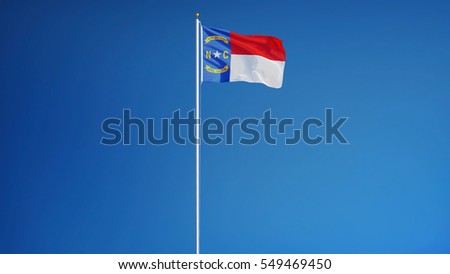 North Carolina (U.S. state) flag waving against clear blue sky, long shot, isolated with clipping path mask alpha channel transparency, perfect for film, news, composition
