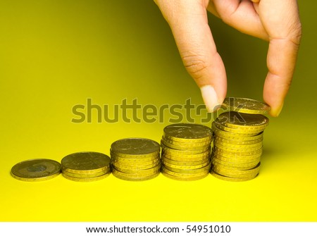 Woman hand holding savings of gold coins