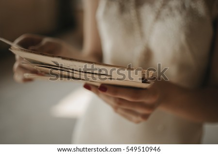 A girl holding a stack of old letters. Royalty-Free Stock Photo #549510946