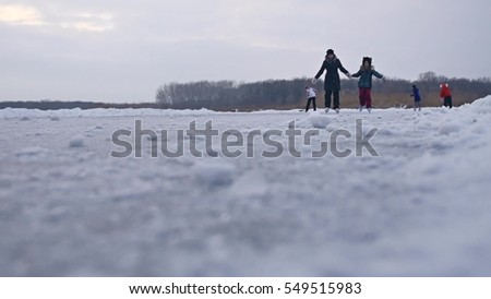People skate on the skating rink in sports the winter on ice, active winter holiday family