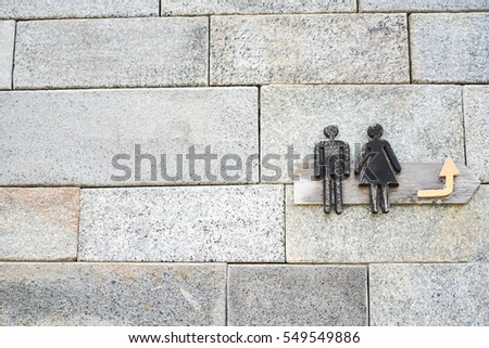 Restroom / Toilet signs with female and male symbol on old brick background. Sign of public toilets WC restroom for Man and Women