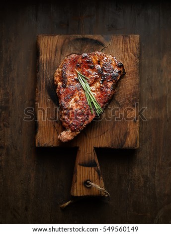 grilled juicy steak with rosemary. top view Royalty-Free Stock Photo #549560149