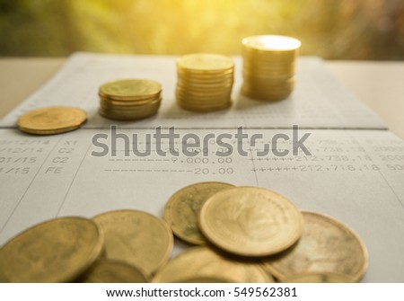 pile coin money with account book finance and banking concept for background.