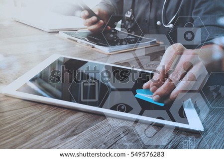 Designer Businessman hand using smart phone,mobile payments online shopping,omni channel,digital tablet docking keyboard computer in modern office on wooden desk,virtual interface icons screen