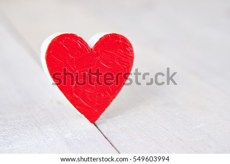 Heart on white wood background