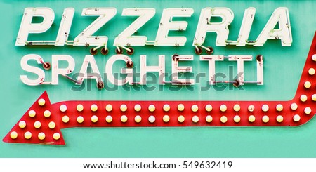 Detail of restaurant sign with words pizzeria and spaghetti