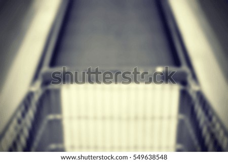 Blurred abstract background and can be illustration to article of cart on escalator in mall