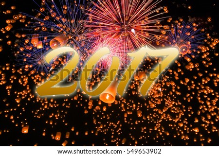 Gold  2017 happy new year on lanterns with fireworks background.