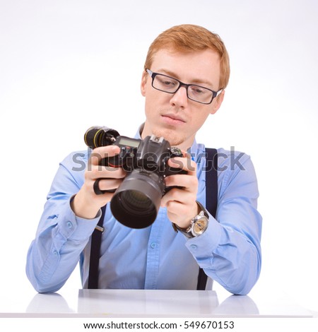 Stylish guy with a camera. Photo on a white background.