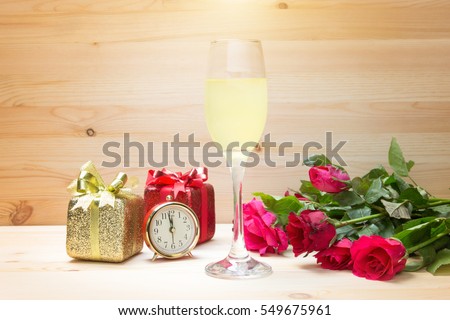 time to dating in valentine with champagne present rose flower on wood background