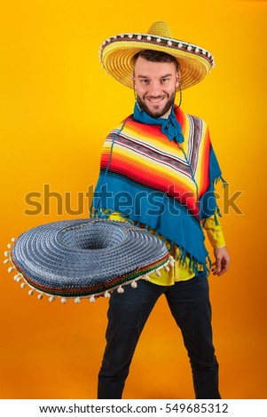 Cheerful and funny man with a Mexican sambrero on a yellow background