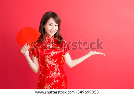 beauty woman show something and take red envelopes in chinese new year Royalty-Free Stock Photo #549699055