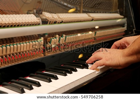 Someone plays piano, close up piano, white and black keyboard