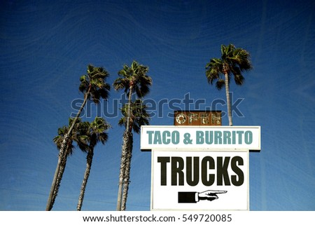 aged and worn vintage photo of tacos and burritos sign with palm trees                             