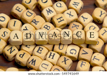 Advance word written on wood block
