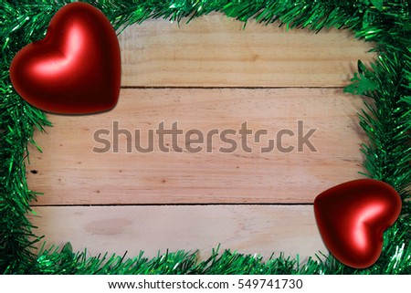 decoration on wooden board background. Heart on a wooden floor. Background Valentine's Day with hearts. Space for text. Top view.