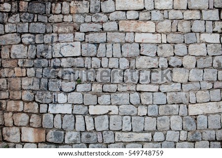 Stones wall of old city in Europe Royalty-Free Stock Photo #549748759