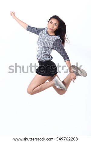 Geeky hipster jumping and smiling, gray shirt black short jean, air walk jump moving concept, motion blur, studio lighting white background