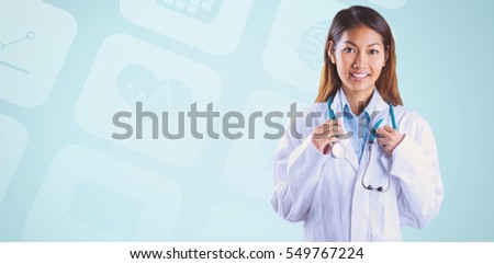 Asian doctor holding stethoscope against medical icons