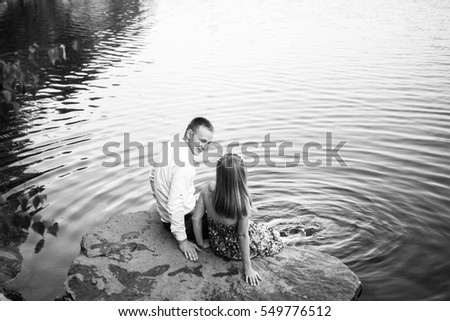 Young couple on the rocks near the water