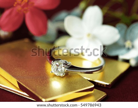 Diamond Ring on Gold Bar Flower Background