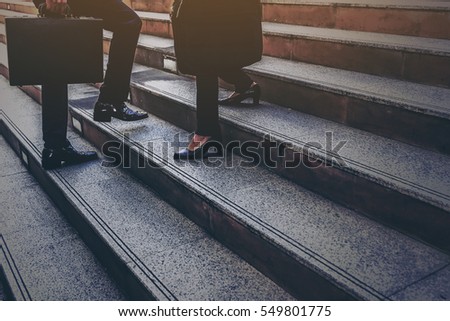 Moment Businessman running fast upstairs. Horizontal outdoors shot,image leg walking up stairs in city to success,Space for copy text. Royalty-Free Stock Photo #549801775