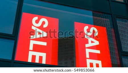 sale signs at shopping windows