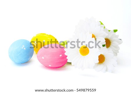 Easter colored eggs with white chamomile om white